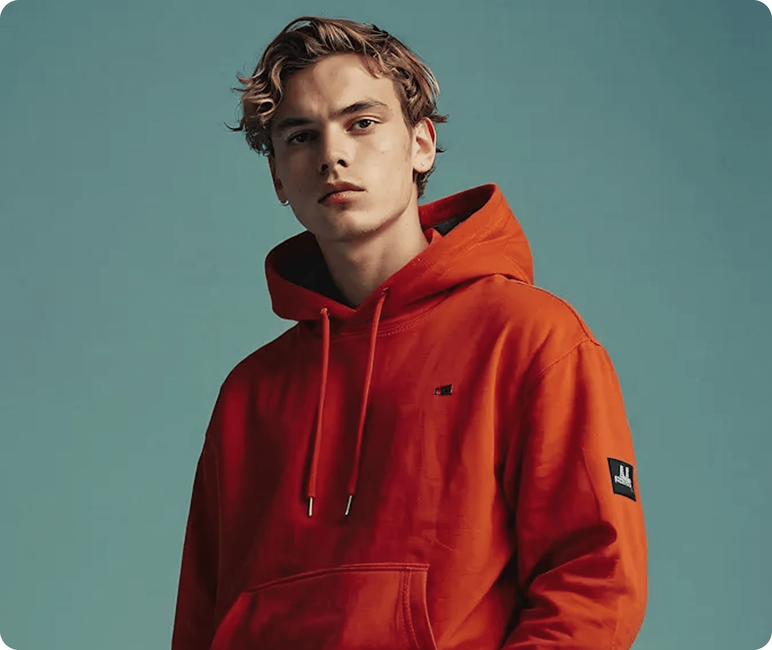 Model wearing orange Aevian hoodie