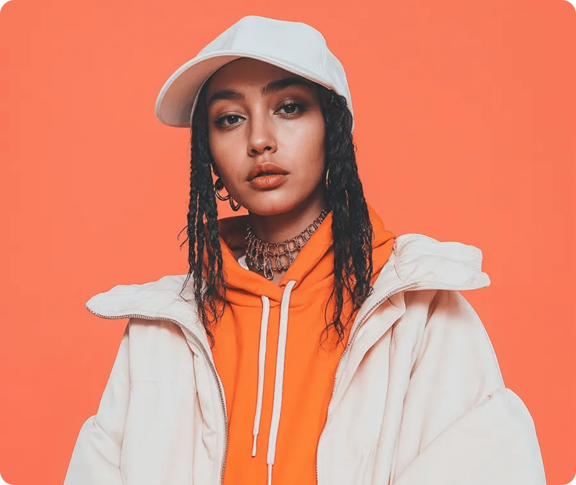 Model wearing orange Aevian hoodie